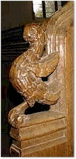 A bird on a bench end - All Saints, Thornham