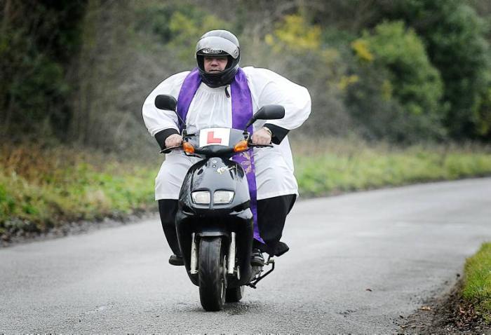FAST LANE:
The Rev. Christopher Wood
on his scooter between services. FAST LANE:
The Rev. Christopher Wood
on his scooter between services.